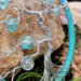 close up details show tree branches, trunk, and beads 